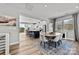 Dining area and kitchen with a dark island, stainless steel appliances and modern pendant lights at 3321 Treble Ct, Charlotte, NC 28262