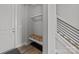 Inviting entryway with a built-in bench, storage shelf, and modern railing at 3321 Treble Ct, Charlotte, NC 28262