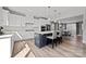 Open concept kitchen with island, stainless appliances, modern lighting, and easy access to the dining and living areas at 3321 Treble Ct, Charlotte, NC 28262