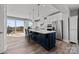 Modern kitchen with white cabinets, dark island, and stainless steel appliances at 3321 Treble Ct, Charlotte, NC 28262