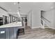 Open kitchen with modern appliances, island seating, and an open floor plan leading to a dining and living area at 3321 Treble Ct, Charlotte, NC 28262
