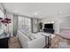 Cozy living room with a gray sofa, large windows, and a view of the backyard at 3321 Treble Ct, Charlotte, NC 28262