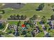 Beautiful aerial view of a home on a golf course with mature trees and a pond at 3506 Cardiff Ln, Matthews, NC 28104