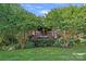 Expansive backyard with manicured lawn and hydrangeas provides a serene view of the home's private outdoor space at 3506 Cardiff Ln, Matthews, NC 28104