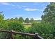 Backyard view from the deck shows lush greenery and a distant fairway offers a peaceful outdoor experience at 3506 Cardiff Ln, Matthews, NC 28104