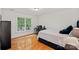 Bedroom with hardwood floors and a window view, providing a comfortable and bright space for relaxation at 3506 Cardiff Ln, Matthews, NC 28104