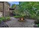 Secluded backyard fire pit offers a cozy brick patio with seating, perfect for relaxing and entertaining outdoors at 3506 Cardiff Ln, Matthews, NC 28104