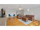 Spacious living room with hardwood floors and plenty of seating, creating a warm and inviting gathering space at 3506 Cardiff Ln, Matthews, NC 28104