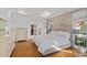 Spacious primary bedroom features a tufted headboard, hardwood floors, and a walk-in closet for ample storage at 3506 Cardiff Ln, Matthews, NC 28104