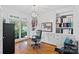 Stylish home office featuring custom built-ins, hardwood floors and a large sunny window at 3506 Cardiff Ln, Matthews, NC 28104