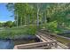 Expansive backyard with lush trees and a wooden bridge, ideal for waterfront enjoyment at 392 Stonemarker Rd, Mooresville, NC 28117