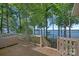 Inviting deck featuring a hot tub and stunning lake views, perfect for relaxing and entertaining at 392 Stonemarker Rd, Mooresville, NC 28117