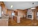 Open-concept living area featuring a brick fireplace, hardwood floors, and ample natural light at 392 Stonemarker Rd, Mooresville, NC 28117