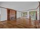 Large living room with a fireplace, built-in bookshelves, hardwood floors, and plenty of natural light at 392 Stonemarker Rd, Mooresville, NC 28117