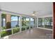 Bright sunroom with panoramic lake views, surrounded by lush greenery creating a serene and relaxing space at 392 Stonemarker Rd, Mooresville, NC 28117