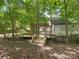 Backyard features a wood bridge, pergola with seating, and lush landscaping at 406 Wilcrest Dr, Matthews, NC 28105