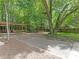 Backyard features a wooden pergola with built-in benches and lush greenery at 406 Wilcrest Dr, Matthews, NC 28105