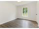 Bedroom with fresh paint, window overlooking landscaped yard and modern flooring at 406 Wilcrest Dr, Matthews, NC 28105