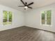 Bedroom with fresh paint, new flooring and two windows overlooking the fenced yard at 406 Wilcrest Dr, Matthews, NC 28105