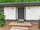Inviting front door with brick steps, new lighting and fresh landscaping at 406 Wilcrest Dr, Matthews, NC 28105