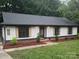 Charming ranch-style home with white siding, black trim, and decorative cedar shutters at 406 Wilcrest Dr, Matthews, NC 28105