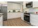 Kitchen featuring white cabinets, granite countertops, and stainless steel appliances at 406 Wilcrest Dr, Matthews, NC 28105