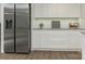 Kitchen featuring white cabinets, granite countertops, and stainless steel appliances at 406 Wilcrest Dr, Matthews, NC 28105