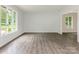Bright living room featuring new laminate floors and neutral paint at 406 Wilcrest Dr, Matthews, NC 28105