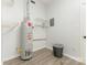 Utility room with water heater, storage shelves, and neutral wall color at 406 Wilcrest Dr, Matthews, NC 28105