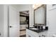 Modern bathroom boasts black countertop, white cabinets, and contemporary fixtures at 407 Newstyle Way, Gastonia, NC 28056