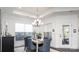 Bright dining room features modern chandelier, neutral paint, and views from two large windows at 407 Newstyle Way, Gastonia, NC 28056