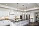 Modern kitchen featuring white cabinetry, granite countertop, and an expansive island at 407 Newstyle Way, Gastonia, NC 28056