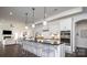 Open-concept kitchen with large island, modern appliances, and bar seating at 407 Newstyle Way, Gastonia, NC 28056
