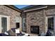 Stylish outdoor seating area featuring a cozy fireplace and elegant brick accents at 407 Newstyle Way, Gastonia, NC 28056