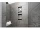Modern shower with gray tiling, recessed niche, and minimalist design at 407 Newstyle Way, Gastonia, NC 28056