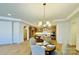 Dining room adjacent to kitchen features modern light fixture and hardwood floors at 409 Newstyle Way, Gastonia, NC 28056
