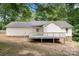Back exterior view of the home showcases a large deck and private yard at 410 Glass Ct, Kannapolis, NC 28081