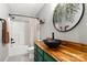 Charming bathroom with wood counter, bold green vanity, vessel sink and shower with curtain at 410 Glass Ct, Kannapolis, NC 28081