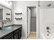 Modern bathroom featuring a vessel sink, dark cabinetry, floating shelves and a shower at 410 Glass Ct, Kannapolis, NC 28081