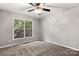 Neutral bedroom featuring gray carpet and a large window that allows natural light to fill the room at 410 Glass Ct, Kannapolis, NC 28081
