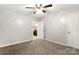Carpeted bedroom offers neutral paint, a ceiling fan and ensuite access to an updated bathroom at 410 Glass Ct, Kannapolis, NC 28081