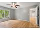 Well-lit bedroom showcases hardwood floors and a large window overlooking the exterior landscape at 410 Glass Ct, Kannapolis, NC 28081