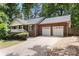 Charming brick home featuring a two-car garage and a well-manicured front yard at 410 Glass Ct, Kannapolis, NC 28081