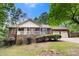 Inviting brick home with a cozy front porch and a well-maintained lawn at 410 Glass Ct, Kannapolis, NC 28081