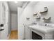 Clean laundry room with modern appliances and wooden shelves at 410 Glass Ct, Kannapolis, NC 28081