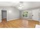 Spacious living room with hardwood floors, a ceiling fan, and a window view at 410 Glass Ct, Kannapolis, NC 28081