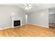 Open-concept living room with hardwood floors and a classic fireplace at 410 Glass Ct, Kannapolis, NC 28081