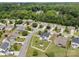 Aerial view captures the neighborhood and manicured backyard enclosed by a white fence at 423 Courtland Ct, Kannapolis, NC 28081