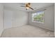 Bedroom featuring neutral carpeting, a ceiling fan, and a window, providing a cozy and relaxing space at 423 Courtland Ct, Kannapolis, NC 28081