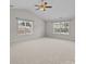 Bright bedroom with neutral carpeting, two windows, and a ceiling fan, creating a comfortable and inviting atmosphere at 423 Courtland Ct, Kannapolis, NC 28081